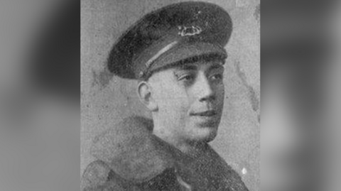 A black and white picture of Fred Potts, who is wearing a military cap and a coat. He is looking away from the camera and into the distance.
