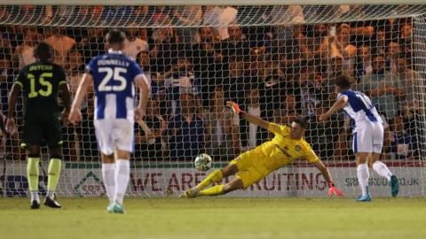 Hakon Valdimarsson saves Jack Payne's second-half penalty in the EFL Cup second-round tie between Colchester and Brentford