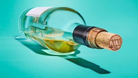 Empty corked wine bottle on its side 