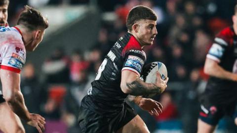 Amir Bourouh runs with the ball during a game