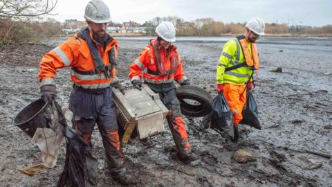 Workers collect rubbish