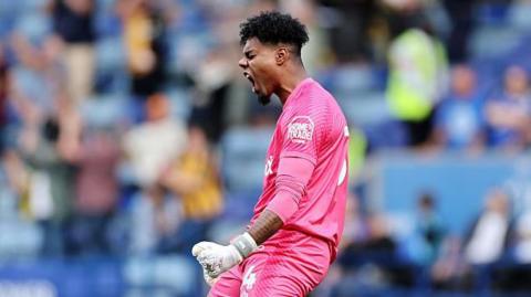 Burton goalkeeper Corey Addai celebrates