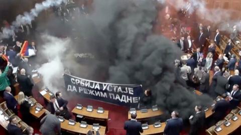 The Serbian Parliament filled with black smoke