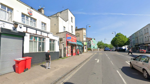 The pub on Ashley Road. There is a double carriageway road, with a number of takeaway businesses on the street. 