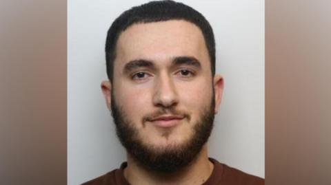 A mugshot of Muhamadi.