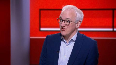 James Gallagher in blue suit