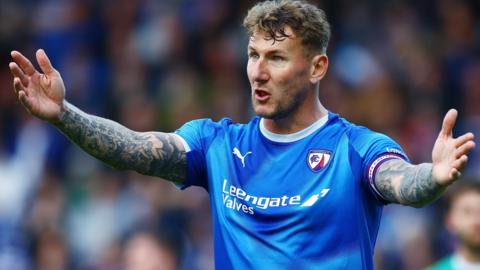 Kyle McFadzean in action for Chesterfield with arms outstretched