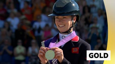 Charlotte Fry holds up her gold medal