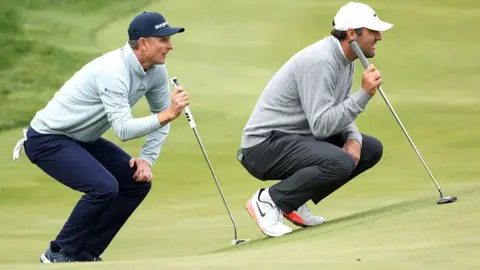Justin Rose and Scottie Scheffler weigh up putts