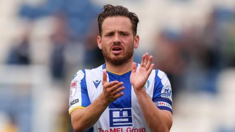 Jack Payne applauds Colchester United's supporters