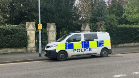 Police van outside cemetery