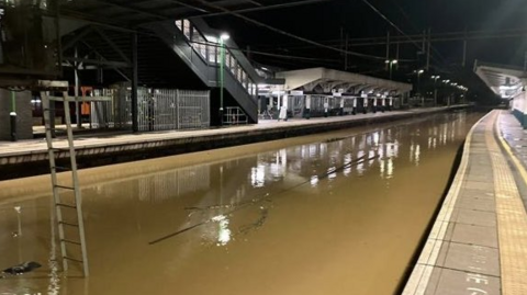 Tracks at Northampton station are covered by floodwater