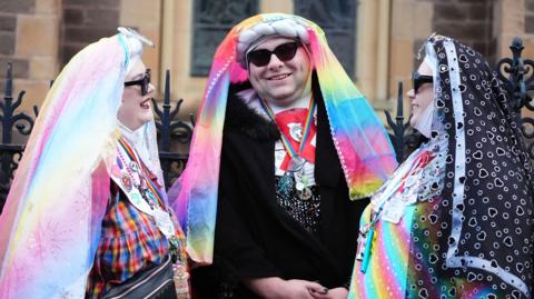 colourfully-dressed friends at the funeral