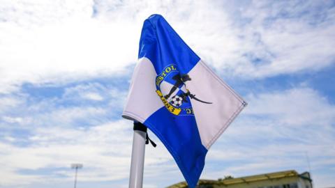 A corner flag with the Bristol Rovers club badge on it inside the Memorial Stadium