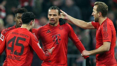 Harry Kane celebrates with Bayern Munich players