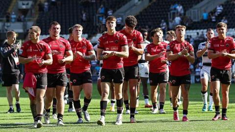 Salford Red Devils' young squad applauds after their heavy defeat by Hull FC earlier in August