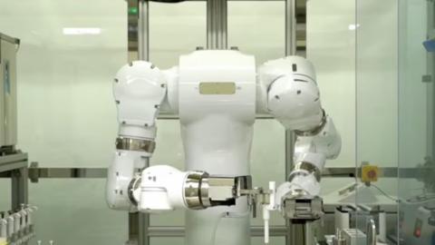 A big white robot with arms in a science lab
