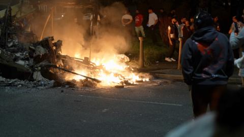 The remains of a burning bus