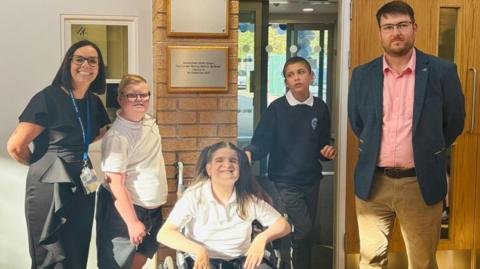 Councillor Sam Redfern stood in SEND school by students Meyra, Ashton and Szymon