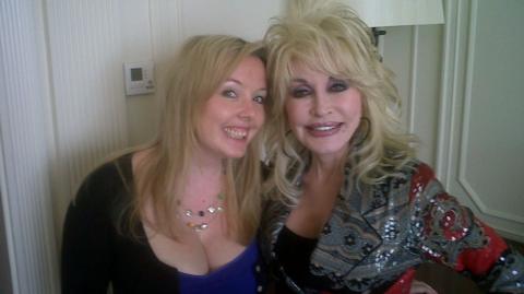 Smiling blonde Jade Wright, former music editor of the Liverpool Echo, smiles next to Dolly Parton, wearing a sequinned grey jacket