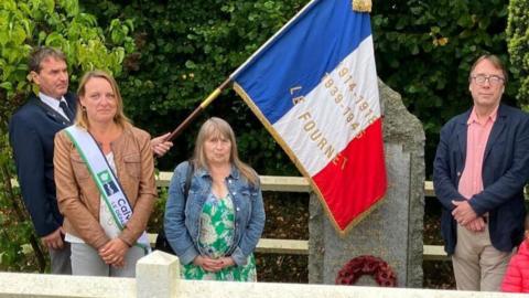 French villagers stood next to a memorial remembering six soldiers