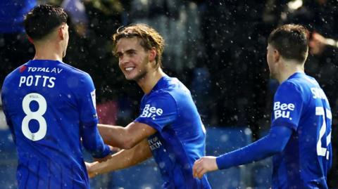 Ryley Towler celebrates scoring for Portsmouth against Swansea