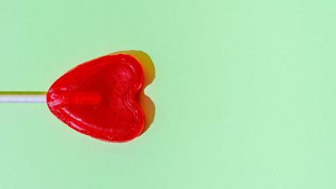 heart shape lollipop on green background