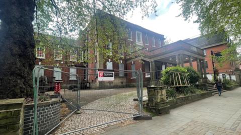 Exterior of the Friary in Derby which is three storeys tall and has boarded up windows.