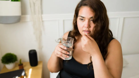 Woman taking pill