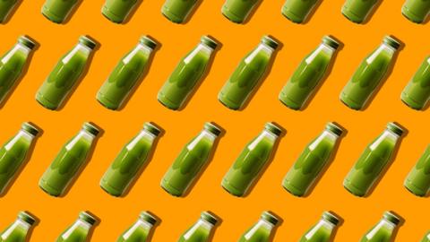 Smoothie and juice bottles pattern on an orange background