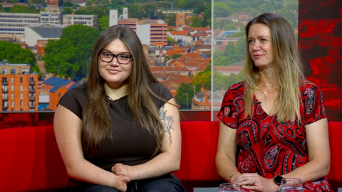 Pianist Grace Matthews and her mum sitting on a TV studio sofa.