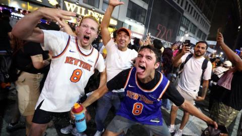 New York Knicks fans celebrate outside Madison Square Garden after their team's Game 4 victory over the San Antonio Spurs in the NBA Finals in New York