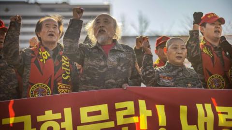 South Korean veteran marines take part in a protest against the president, outside the presidential office on December 05, 2024 in Seoul, South Korea.