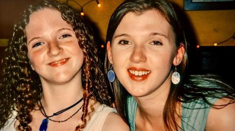 Emily Talbot is pictured with her sister Elizabeth. They are both young women but Emily has very curly hair whereas Elizabeth's is straight. They are both smiling.