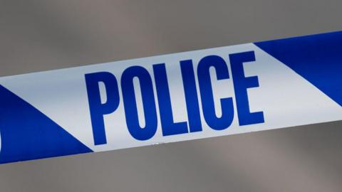 A close-up of blue and white police tape.