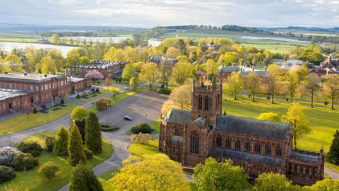 An aerial view of the Crichton Estate with sandstone buildings and green rolling fields