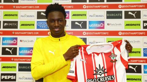 Southampton's latest signing Issa Tounkara poses for a photo holding the shirt