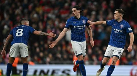 Ipswich players celebrate scoring against Liverpool