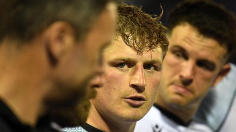 Jac Morgan listens to Ospreys head coach Mark Jones in a team huddle
