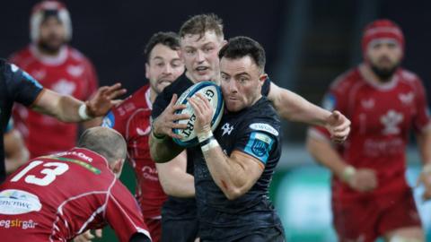 Ospreys wing Luke Morgan is tackled by Scarlets centre Ioan Nicholas in December 2022 