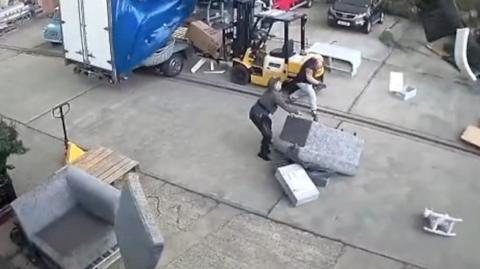 CCTV captures mattresses and other heavy objects being tossed into the air, narrowly missing staff.