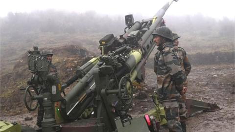 Indian Army soldiers stand next to a M777 Ultra Lightweight Howitzer positioned at Penga Teng Tso ahead of Tawang, near the Line of Actual Control (LAC),