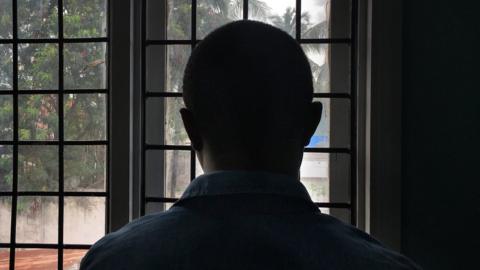 A gay man with HIV stands in a clinic in Dar es Salaam, Tanzania, 2016