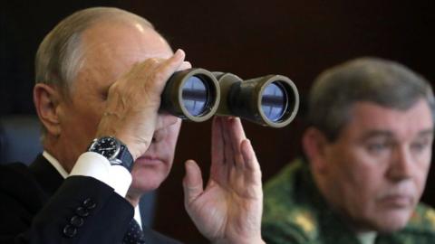 Russian President Vladimir Putin (L), accompanied by Chief of the General Staff Valery Gerasimov, watches the joint Belarus-Russian Zapad-2017 military exercises