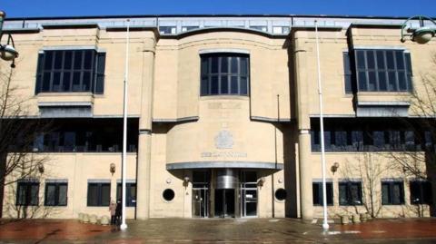 The outside of Bradford Crown Court - a large concrete building 