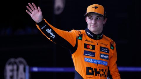 Oscar Piastri waves to fans