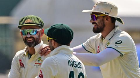 Australia's Nathan Lyon, Josh Inglis and Mitchell Starc celebrate wickets