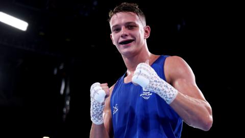 Sonny Kerr of Team Scotland poses for a photo after victory against Marion Ah Tong of Team Samoa in the Men's 70kg Quarter-Final match on day six of the Glasgow 2026 Commonwealth Games
