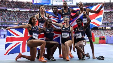 Great Britain's women and men's relay teams celebrate their respective silver and bronze 4x100m medals