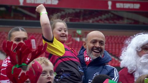 Nottingham Forest boss Nuno Espirito Santo holds up a Reds fan at a Christmas event